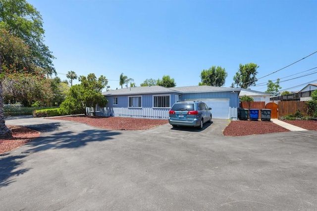 8802 Tyler St, Spring Valley, CA 91977 - ranch-style home featuring asphalt driveway and an attached garage