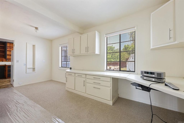 8802 Tyler St, Spring Valley, CA 91977 - kitchen with built in desk, light colored carpet, plenty of natural light, light countertops, and beamed ceiling