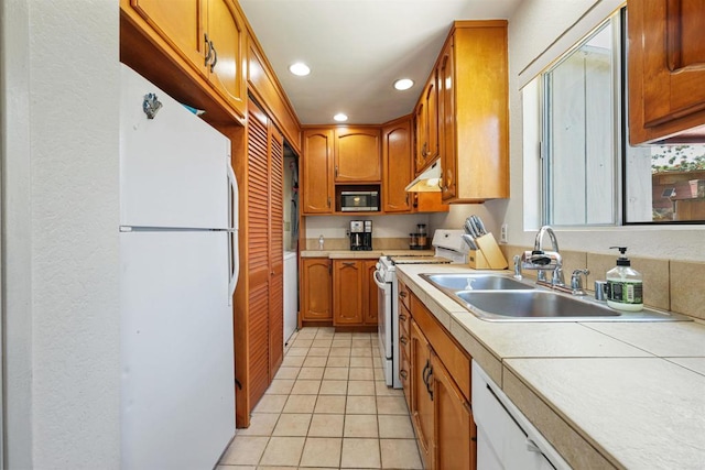 8802 Tyler St, Spring Valley, CA 91977 - kitchen featuring white appliances, light countertops, light tile patterned floors, under cabinet range hood, and recessed lighting