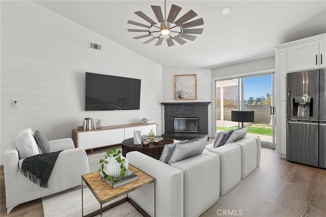 662 January St, Nipomo, CA 93444 - living area with vaulted ceiling, a fireplace, wood finished floors, and ceiling fan