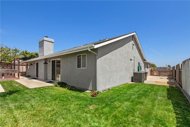 662 January St, Nipomo, CA 93444 - back of property with a patio area, a fenced backyard, a chimney, and stucco siding