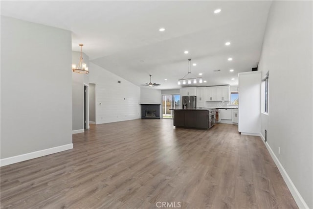 662 January St, Nipomo, CA 93444 - living area with a chandelier, lofted ceiling, recessed lighting, light wood-style flooring, and a fireplace