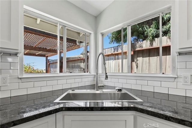 662 January St, Nipomo, CA 93444 - kitchen featuring white cabinetry, tasteful backsplash, and dark stone counters
