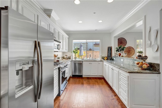 6 Camino Celeste, San Clemente, CA 92673 - kitchen with stainless steel appliances, white cabinets, dark wood finished floors, light stone counters, and recessed lighting