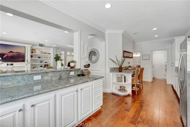 6 Camino Celeste, San Clemente, CA 92673 - kitchen with freestanding refrigerator, crown molding, white cabinets, hardwood / wood-style flooring, and recessed lighting