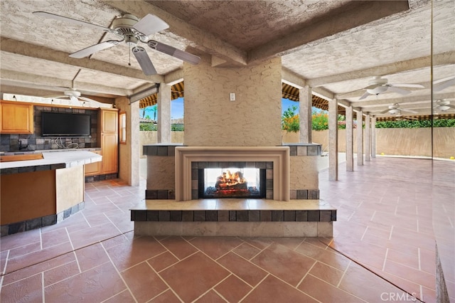 75406 Montecito Dr, Indian Wells, CA 92210 - view of patio with a tiled fireplace and a ceiling fan