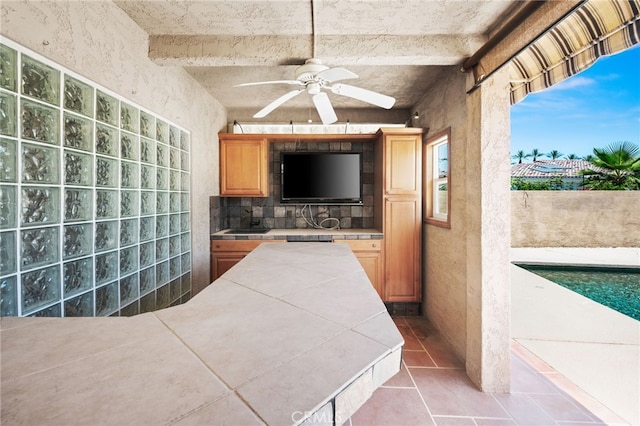 75406 Montecito Dr, Indian Wells, CA 92210 - view of patio with a ceiling fan, an outdoor kitchen, and an outdoor pool