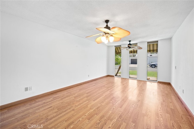 75406 Montecito Dr, Indian Wells, CA 92210 - spare room featuring light wood-style flooring, a ceiling fan, and a textured ceiling