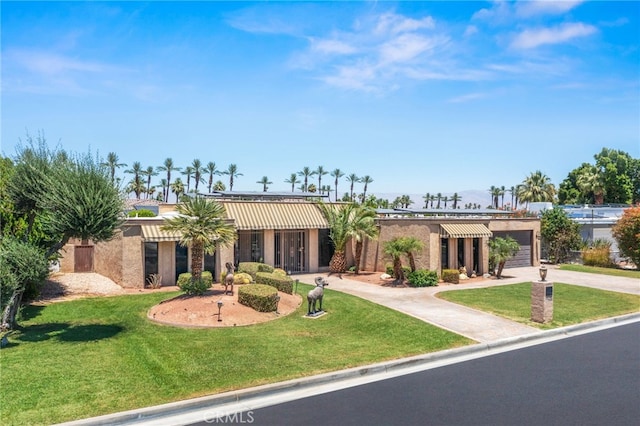 75406 Montecito Dr, Indian Wells, CA 92210 - single story home with concrete driveway, a garage, a front yard, and stucco siding