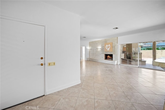 75406 Montecito Dr, Indian Wells, CA 92210 - unfurnished living room featuring a fireplace and light tile patterned floors