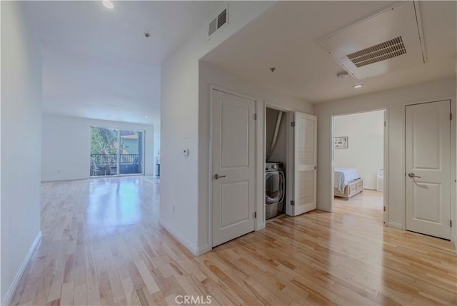 4568 W 1st St Unit 203, Los Angeles, CA 90004 - corridor featuring washer / dryer and light wood-style floors