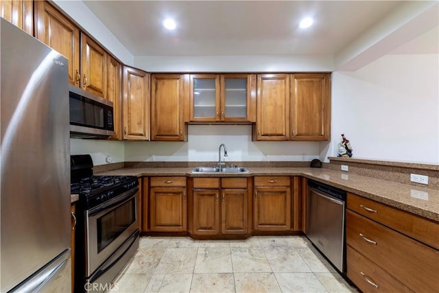 4568 W 1st St Unit 203, Los Angeles, CA 90004 - kitchen featuring stainless steel appliances, brown cabinets, glass insert cabinets, and recessed lighting