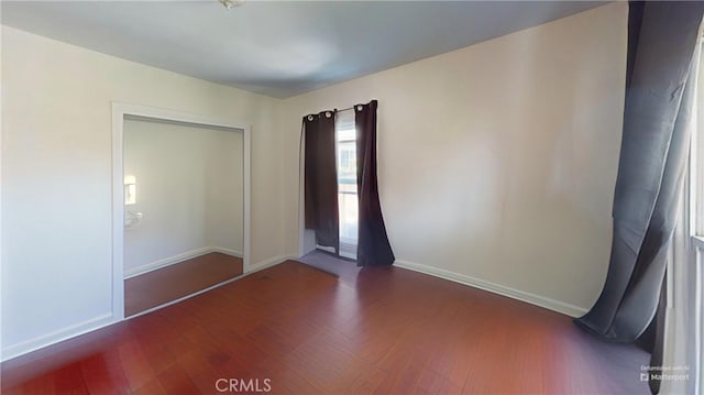 2372 W 29th Pl, Los Angeles, CA 90018 - unfurnished bedroom featuring baseboards and wood finished floors