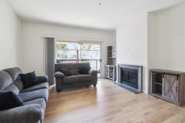 2960 Champion Way Unit 1006, Tustin, CA 92782 - living area with light wood finished floors and a fireplace with raised hearth