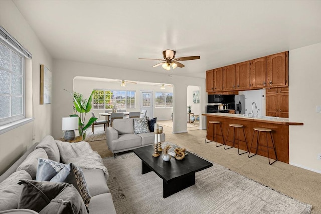5530 Heidi St, La Mesa, CA 91942 - living area with a ceiling fan, light colored carpet, and arched walkways