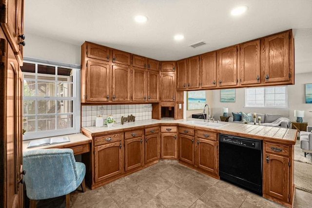 5530 Heidi St, La Mesa, CA 91942 - kitchen featuring black dishwasher, a peninsula, brown cabinets, tasteful backsplash, and recessed lighting