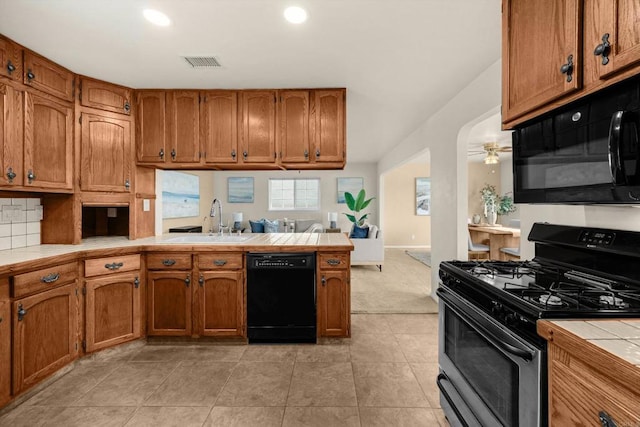 5530 Heidi St, La Mesa, CA 91942 - kitchen with black appliances, tile counters, a peninsula, open floor plan, and brown cabinetry