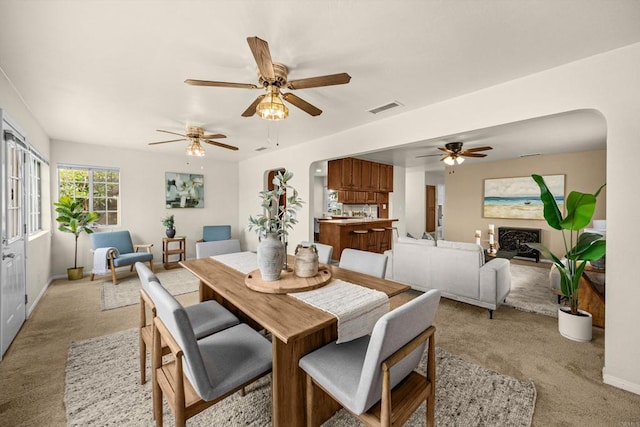5530 Heidi St, La Mesa, CA 91942 - dining area featuring light colored carpet, a ceiling fan, and arched walkways
