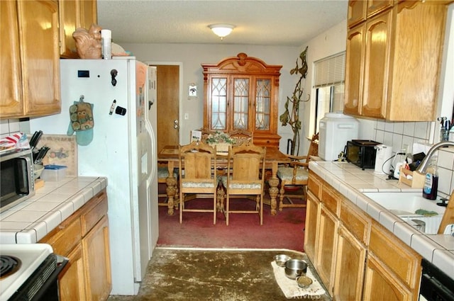 30717 Seminole Dr, Coarsegold, CA 93614 - kitchen featuring tile counters, stainless steel microwave, and tasteful backsplash