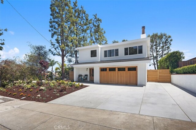 32862 Bluffside Dr, Dana Point, CA 92629 - view of front of property with concrete driveway, an attached garage, and a chimney