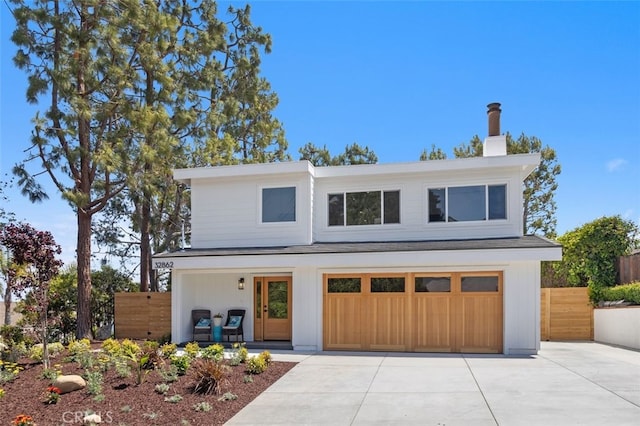 32862 Bluffside Dr, Dana Point, CA 92629 - modern home with driveway, a chimney, and a garage