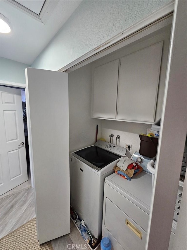 24377 Larchmont Ct Unit 32, Laguna Hills, CA 92653 - laundry room with cabinet space and washer and dryer