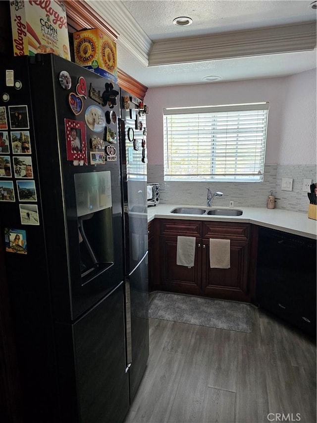 24377 Larchmont Ct Unit 32, Laguna Hills, CA 92653 - kitchen featuring black fridge with ice dispenser, wood finished floors, crown molding, light countertops, and backsplash