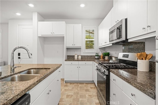 5603 Kate Way Unit 4, Fontana, CA 92336 - kitchen with appliances with stainless steel finishes, white cabinetry, dark stone counters, stone finish flooring, and recessed lighting