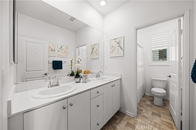 5603 Kate Way Unit 4, Fontana, CA 92336 - bathroom with double vanity, stone finish floors, and a shower with curtain