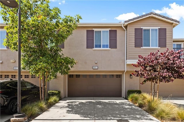 5603 Kate Way Unit 4, Fontana, CA 92336 - townhome / multi-family property featuring stucco siding, a garage, and concrete driveway