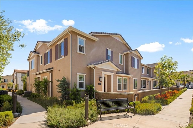 5603 Kate Way Unit 4, Fontana, CA 92336 - view of property featuring stucco siding and a residential view