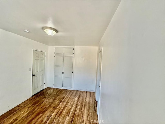 1526 Lakme Ave, Wilmington, CA 90744 - unfurnished bedroom with wood finished floors and a closet