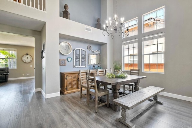 756 River Rock Rd, Chula Vista, CA 91914 - dining room with a chandelier, wood finished floors, and a high ceiling