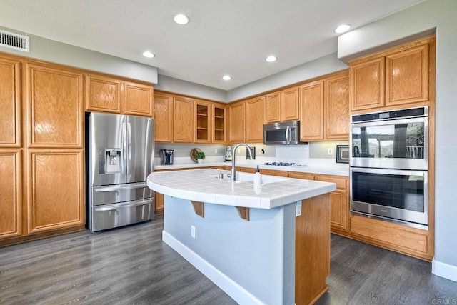 756 River Rock Rd, Chula Vista, CA 91914 - kitchen with stainless steel appliances, tile countertops, dark wood-style floors, a center island with sink, and recessed lighting