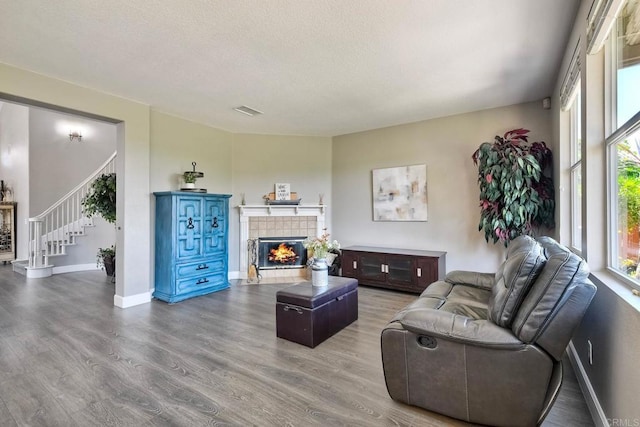 756 River Rock Rd, Chula Vista, CA 91914 - living area with wood finished floors, stairway, a fireplace, and a textured ceiling