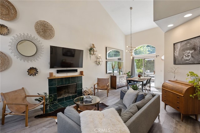 136461/2 Dronfield Ave, Sylmar, CA 91342 - living room with wood finished floors, high vaulted ceiling, a tile fireplace, and recessed lighting