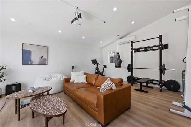 136461/2 Dronfield Ave, Sylmar, CA 91342 - living room featuring an AC wall unit, light wood-style flooring, recessed lighting, and lofted ceiling