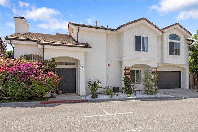 136461/2 Dronfield Ave, Sylmar, CA 91342 - view of front facade featuring a tile roof, stucco siding, a chimney, and a garage