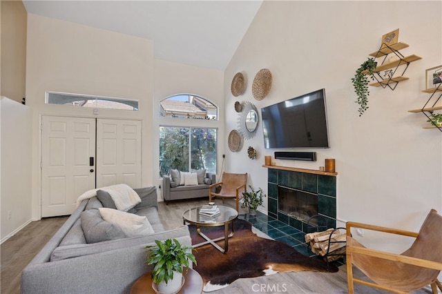 136461/2 Dronfield Ave, Sylmar, CA 91342 - living area with high vaulted ceiling, wood finished floors, and a tile fireplace
