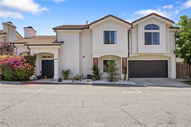 136461/2 Dronfield Ave, Sylmar, CA 91342 - view of front of property featuring a tiled roof, stucco siding, an attached garage, a chimney, and concrete driveway