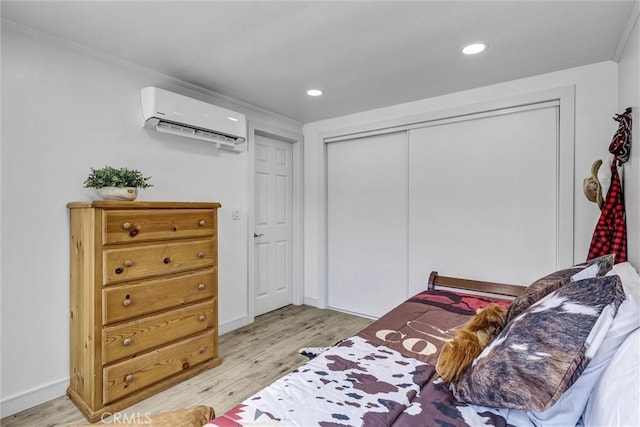 2255 Cota Ave, Long Beach, CA 90810 - bedroom featuring a wall unit AC, light wood-type flooring, recessed lighting, and a closet