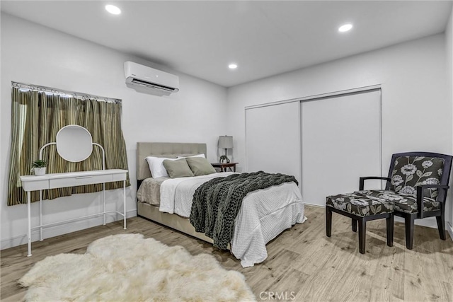2255 Cota Ave, Long Beach, CA 90810 - bedroom featuring an AC wall unit, wood finished floors, a closet, and recessed lighting