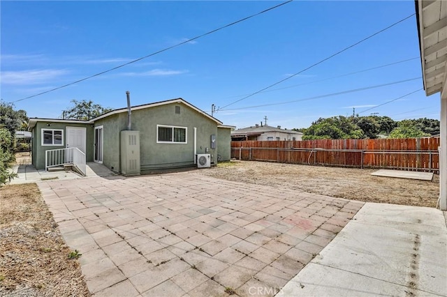 2255 Cota Ave, Long Beach, CA 90810 - rear view of property featuring a patio and stucco siding