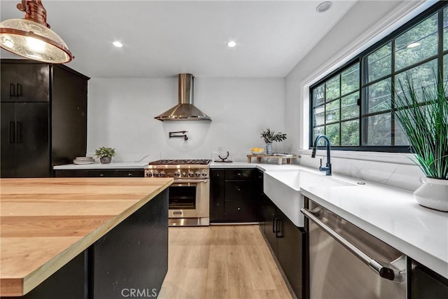 3735 Division St, Los Angeles, CA 90065 - kitchen with stainless steel appliances, wall chimney exhaust hood, healthy amount of natural light, light wood-style floors, and recessed lighting