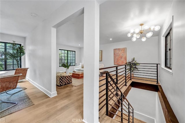 3735 Division St, Los Angeles, CA 90065 - hallway with an upstairs landing, wood finished floors, and a chandelier