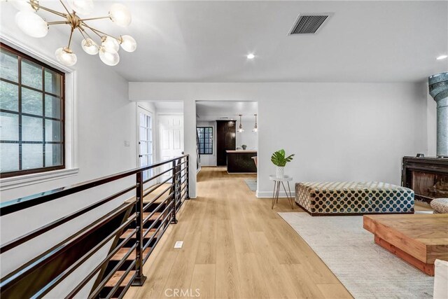 3735 Division St, Los Angeles, CA 90065 - hallway featuring healthy amount of natural light, a chandelier, light wood-style floors, and recessed lighting