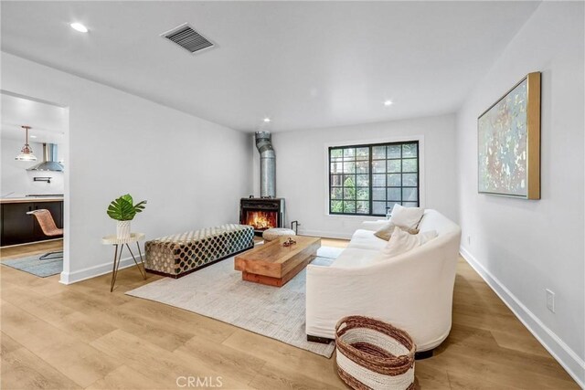 3735 Division St, Los Angeles, CA 90065 - living room with light wood-style flooring, recessed lighting, and a wood stove