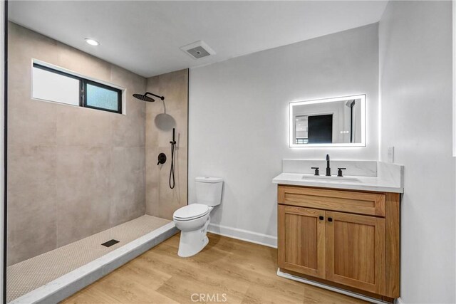3735 Division St, Los Angeles, CA 90065 - bathroom featuring a tile shower, vanity, and wood finished floors