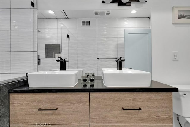 5226 W 20th St, Los Angeles, CA 90016 - full bathroom featuring double vanity, decorative backsplash, a shower stall, and tile walls