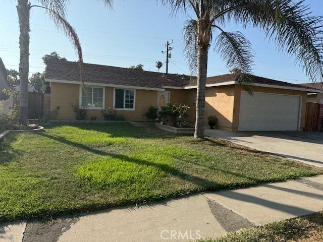 1303 N Siesta Ave, La Puente, CA 91746 - ranch-style home with a garage, driveway, stucco siding, and a front lawn